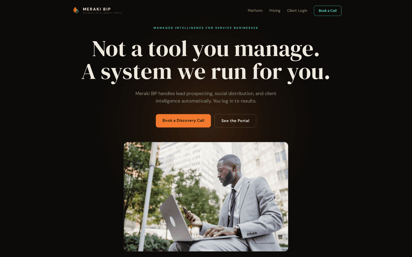 The Meraki BIP homepage hero on a dark screen: the headline 'Not a tool you manage. A system we run for you.' above two buttons, and a photo of a businessman in a suit working on a laptop outdoors below.
